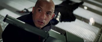 Movie still from “xXx” (2002), directed by Rob Cohen – A man with a bald head looking at the camera; Close Up shot, Low angle