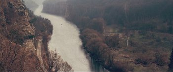 Movie still from “xXx” (2002), directed by Rob Cohen – A body of water surrounded by trees and a body of water; Extreme Wide shot, High angle