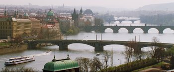 Movie still from “xXx” (2002), directed by Rob Cohen – A view of a city with a bridge in the middle of it; Extreme Wide shot, High angle
