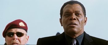 Movie still from “xXx” (2002), directed by Rob Cohen – A person wearing a suit and tie; Close Up shot, Low angle