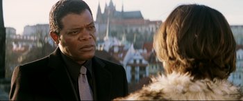 Movie still from “xXx” (2002), directed by Rob Cohen – A man in a suit and tie looking at a woman in a fur coat; Close Up shot, Over the shoulder angle