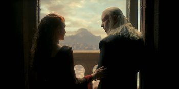 Movie still from “House of the Dragon” (2022), created by George R.R. Martin – A man and a woman holding each other's hands; Medium shot, Over the shoulder angle