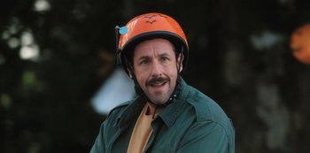 Movie still from “Hubie Halloween” (2020), directed by Steven Brill – A man wearing a helmet and a green jacket; Close Up shot, High angle