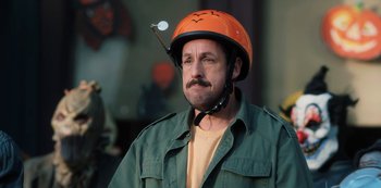 Movie still from “Hubie Halloween” (2020), directed by Steven Brill – A man wearing a orange helmet and a green jacket; Close Up shot, High angle