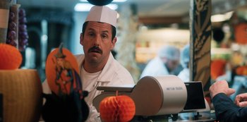 Movie still from “Hubie Halloween” (2020), directed by Steven Brill – A man wearing a chef's hat sitting at a counter; Close Up shot, Over the shoulder angle