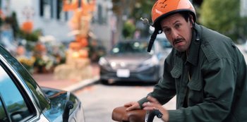 Movie still from “Hubie Halloween” (2020), directed by Steven Brill – A man wearing a helmet on a bicycle; Close Up shot, Over the shoulder angle