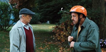 Movie still from “Hubie Halloween” (2020), directed by Steven Brill – A man wearing an orange helmet talking to another man in a park; Medium shot, High angle