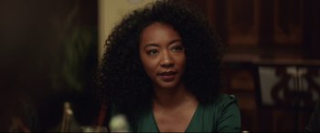 Movie still from “Human Capital” (2019), directed by Marc Meyers – A person wearing a green shirt; Close Up shot, Over the shoulder angle