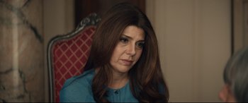 Movie still from “Human Capital” (2019), directed by Marc Meyers – A person sitting in a chair with long brown hair; Close Up shot, Over the shoulder angle