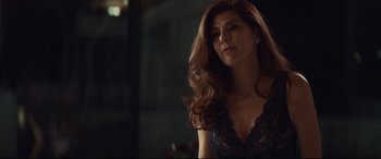 Movie still from “Human Capital” (2019), directed by Marc Meyers – A woman with long red curly hair wearing a black dress; Close Up shot, Over the shoulder angle