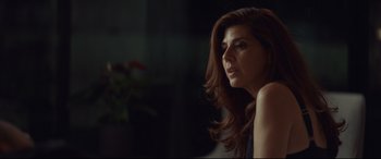 Movie still from “Human Capital” (2019), directed by Marc Meyers – A woman sitting in a room with her hair blowing in the wind; Close Up shot, Over the shoulder angle