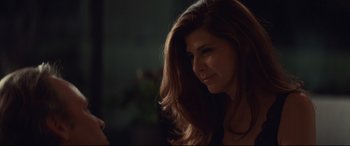 Movie still from “Human Capital” (2019), directed by Marc Meyers – A beautiful woman with long red hair looking to her left; Close Up shot, Over the shoulder angle