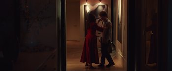 Movie still from “Human Capital” (2019), directed by Marc Meyers – A man and a woman are dancing in a hallway; Wide shot, Over the shoulder angle
