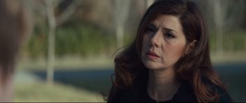 Movie still from “Human Capital” (2019), directed by Marc Meyers – A person with long red hair; Close Up shot, Over the shoulder angle