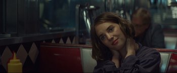 Movie still from “Human Capital” (2019), directed by Marc Meyers – A person sitting in a chair; Close Up shot, Over the shoulder angle