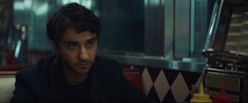 Movie still from “Human Capital” (2019), directed by Marc Meyers – A person sitting at a table; Close Up shot, Over the shoulder angle