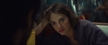 Movie still from “Human Capital” (2019), directed by Marc Meyers – A person sitting down with her hand on her head; Close Up shot, Over the shoulder angle