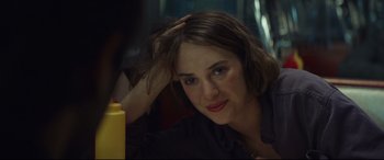 Movie still from “Human Capital” (2019), directed by Marc Meyers – A person sitting in front of a yellow object; Close Up shot, Over the shoulder angle