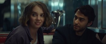 Movie still from “Human Capital” (2019), directed by Marc Meyers – A woman and a man sitting next to each other on a couch; Close Up shot, Over the shoulder angle