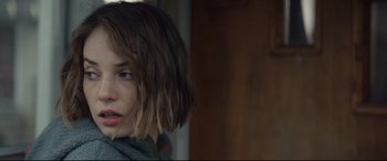 Movie still from “Human Capital” (2019), directed by Marc Meyers – A person with short brown hair; Close Up shot, Over the shoulder angle