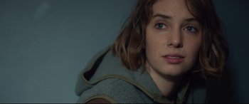 Movie still from “Human Capital” (2019), directed by Marc Meyers – A woman's face in a hooded jacket; Close Up shot, Over the shoulder angle
