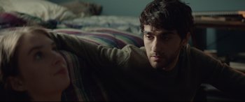 Movie still from “Human Capital” (2019), directed by Marc Meyers – A man laying on a bed looking at the camera; Close Up shot, Over the shoulder angle