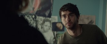 Movie still from “Human Capital” (2019), directed by Marc Meyers – A person in a room near a wall; Close Up shot, Over the shoulder angle