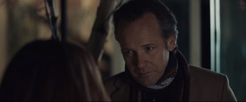 Movie still from “Human Capital” (2019), directed by Marc Meyers – A person looking at a person holding an umbrella; Close Up shot, Over the shoulder angle