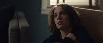 Movie still from “Human Capital” (2019), directed by Marc Meyers – A woman sitting in a chair with her hand on her shoulder; Close Up shot, Over the shoulder angle