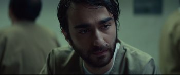 Movie still from “Human Capital” (2019), directed by Marc Meyers – A person with a beard; Close Up shot, High angle