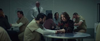 Movie still from “Human Capital” (2019), directed by Marc Meyers – A man and a woman sitting at a round table; Medium shot, Over the shoulder angle