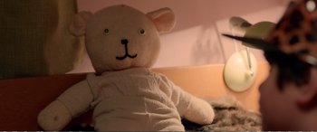 Movie still from “Hunt for the Wilderpeople” (2016), directed by Taika Waititi – A teddy bear is sitting on the ground; Extreme Close Up shot, High angle