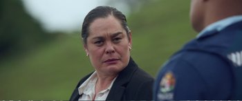 Movie still from “Hunt for the Wilderpeople” (2016), directed by Taika Waititi – A person wearing a suit and tie; Close Up shot, Over the shoulder angle