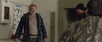Movie still from “Hunt for the Wilderpeople” (2016), directed by Taika Waititi – An older man standing in front of a door; Medium shot, Over the shoulder angle