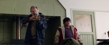 Movie still from “Hunt for the Wilderpeople” (2016), directed by Taika Waititi – A man and a boy are standing next to each other; Medium shot, Over the shoulder angle