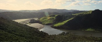 Movie still from “Hunt for the Wilderpeople” (2016), directed by Taika Waititi – A view of a lake and some hills in the background; Extreme Wide shot, High angle