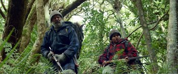 Movie still from “Hunt for the Wilderpeople” (2016), directed by Taika Waititi – A man and a child in the woods with a horse; Medium shot, Low angle