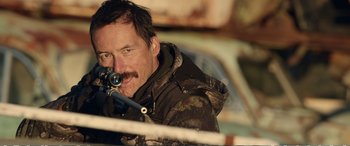 Movie still from “Hunt for the Wilderpeople” (2016), directed by Taika Waititi – A person with a rifle; Close Up shot, Over the shoulder angle