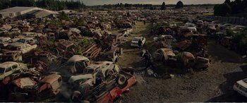 Movie still from “Hunt for the Wilderpeople” (2016), directed by Taika Waititi – An aerial view of an abandoned car graveyard; Extreme Wide shot, High angle