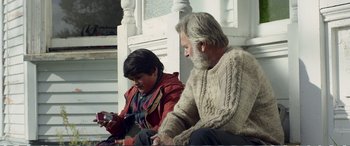 Movie still from “Hunt for the Wilderpeople” (2016), directed by Taika Waititi – An older man sitting next to a young boy; Medium shot, Over the shoulder angle