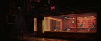 Movie still from “Hustle” (2022), directed by Jeremiah Zagar – People sitting at a table in front of a building; Extreme Wide shot, High angle