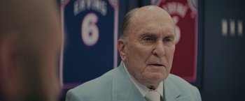 Movie still from “Hustle” (2022), directed by Jeremiah Zagar – An older man wearing a suit and tie; Close Up shot, Low angle