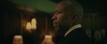 Movie still from “Hustle” (2022), directed by Jeremiah Zagar – A man in a suit looking to his left; Close Up shot, Low angle