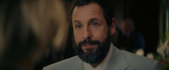 Movie still from “Hustle” (2022), directed by Jeremiah Zagar – A person wearing a suit and beard; Close Up shot, Over the shoulder angle
