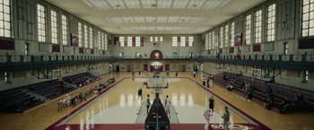 Movie still from “Hustle” (2022), directed by Jeremiah Zagar – A large gym with people playing basketball on the court; Extreme Wide shot, High angle