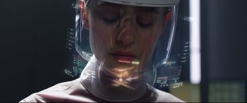 A woman wearing a helmet with a futuristic design