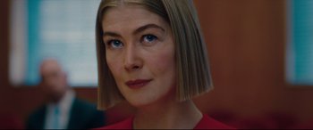 Movie still from “I Care a Lot” (2020), directed by J Blakeson – A person wearing a red shirt; Close Up shot, Low angle