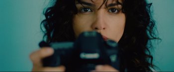 Movie still from “I Care a Lot” (2020), directed by J Blakeson – A woman is taking a picture with a camera; Extreme Close Up shot, Overhead angle