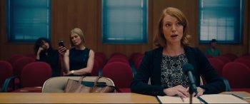 Movie still from “I Care a Lot” (2020), directed by J Blakeson – Two women sitting at a table in a conference room; Medium shot, Over the shoulder angle