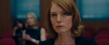 Movie still from “I Care a Lot” (2020), directed by J Blakeson – A person wearing a black shirt; Close Up shot, Over the shoulder angle